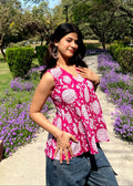 Pink sleeveless peplum top